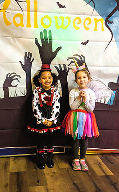 The Halloween costumes: two little girls posing for an image