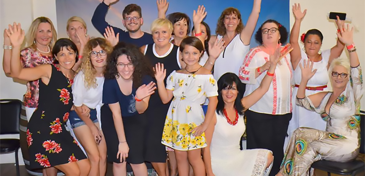 Goup photo of Croatian club ladies waiving in the front of the decoration